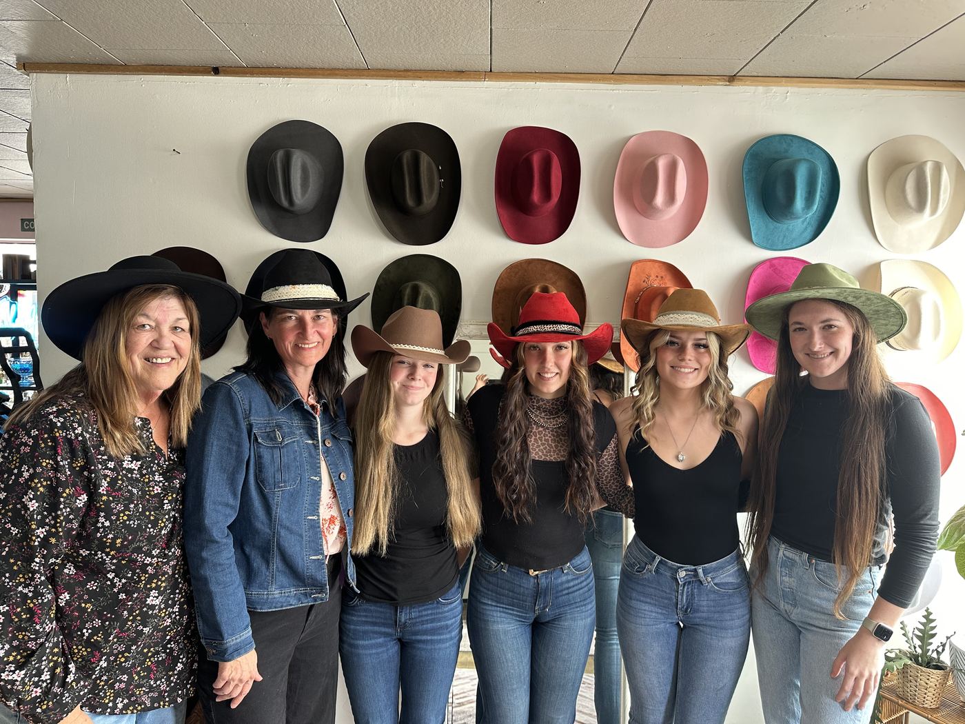 Group wearing colourful custom styled hats at a Saddle N Spurs birthday party
