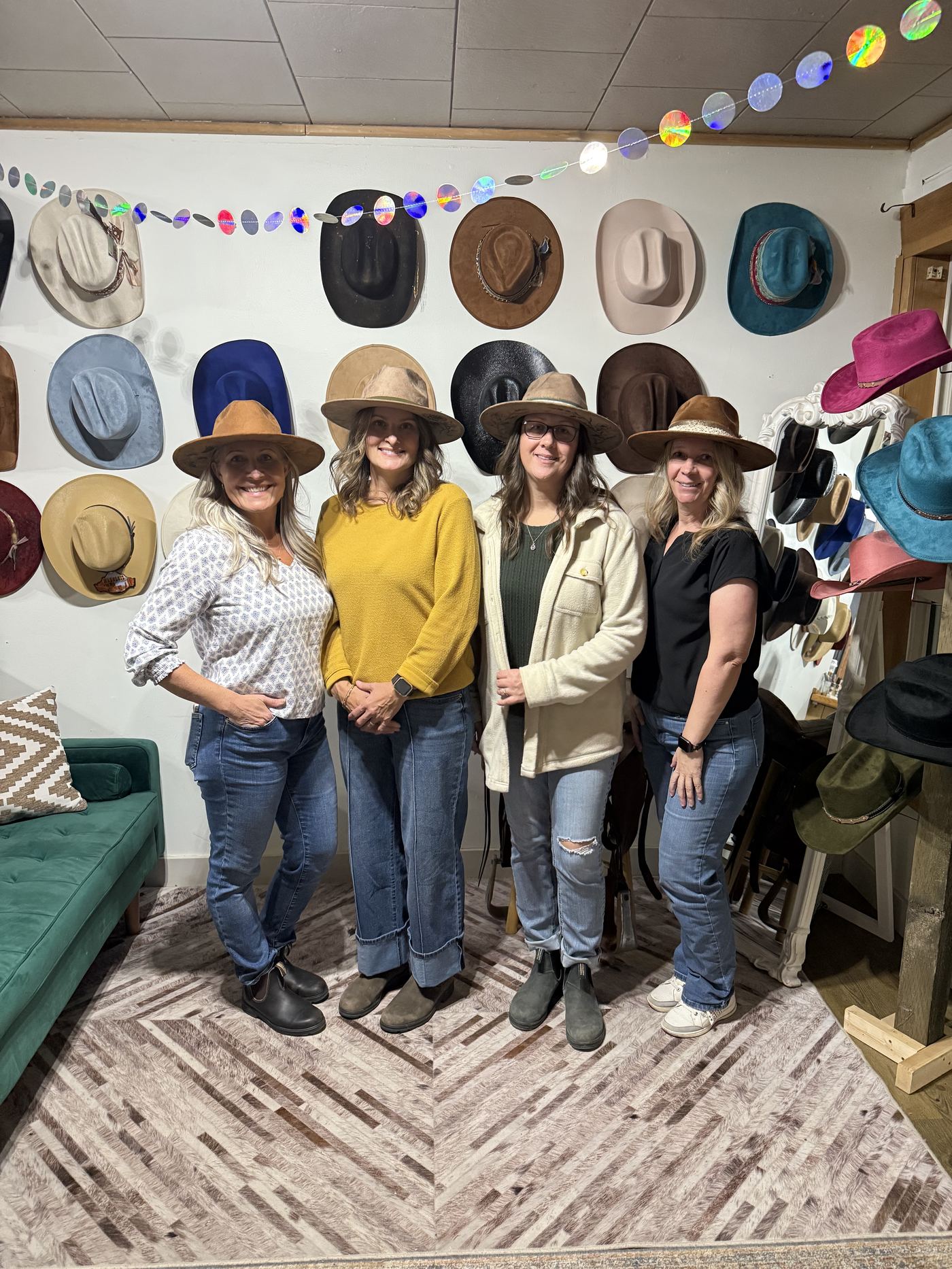 Group gathered by the teal couch at a Saddle N Spurs birthday party