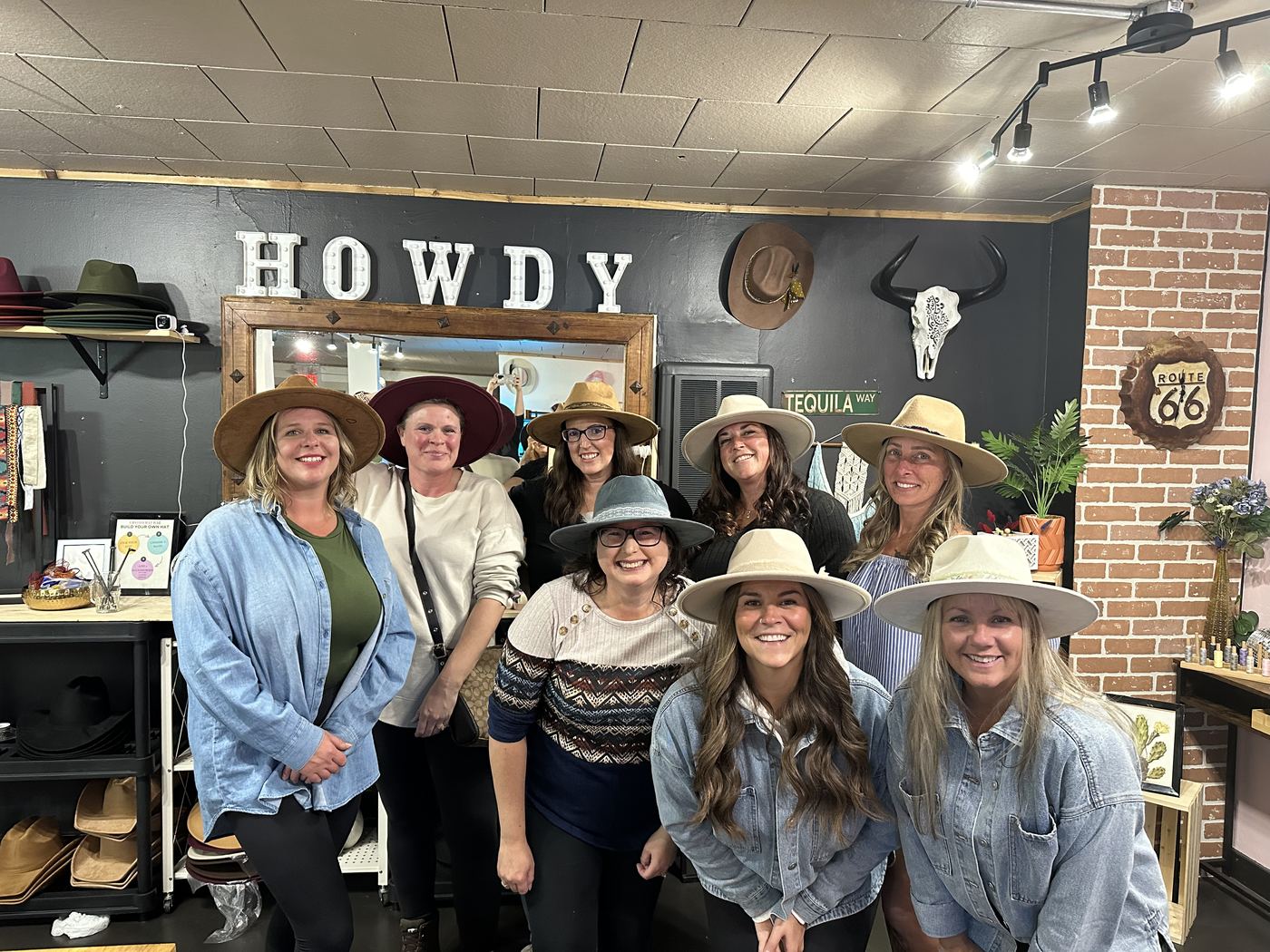 Group photo under the Howdy sign at a Saddle N Spurs birthday party
