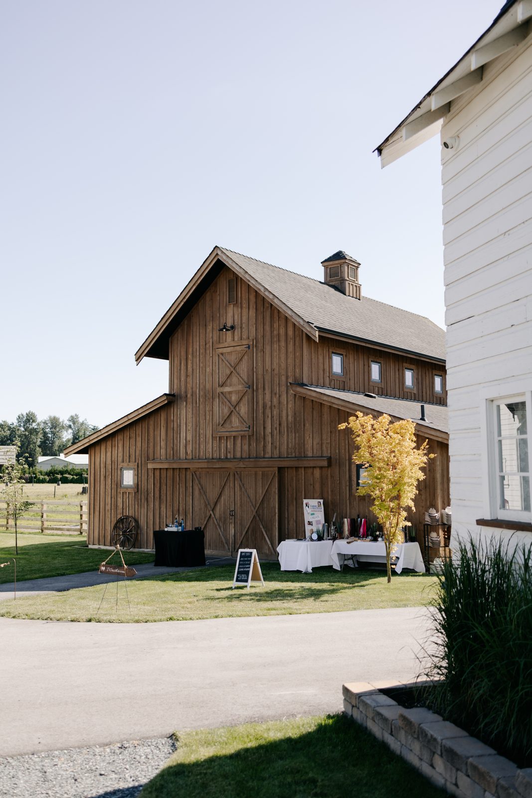 Guests mingling outside a barn venue