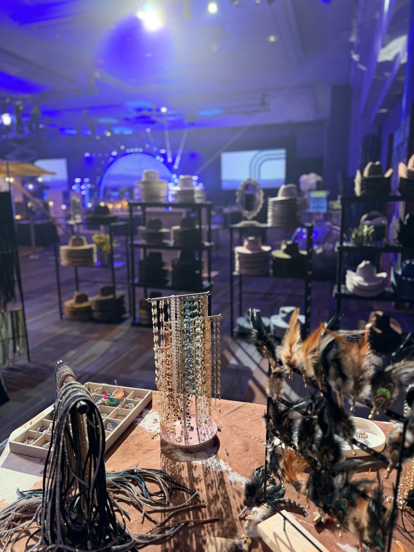 Rack of premium hats on display at a corporate hat bar booth