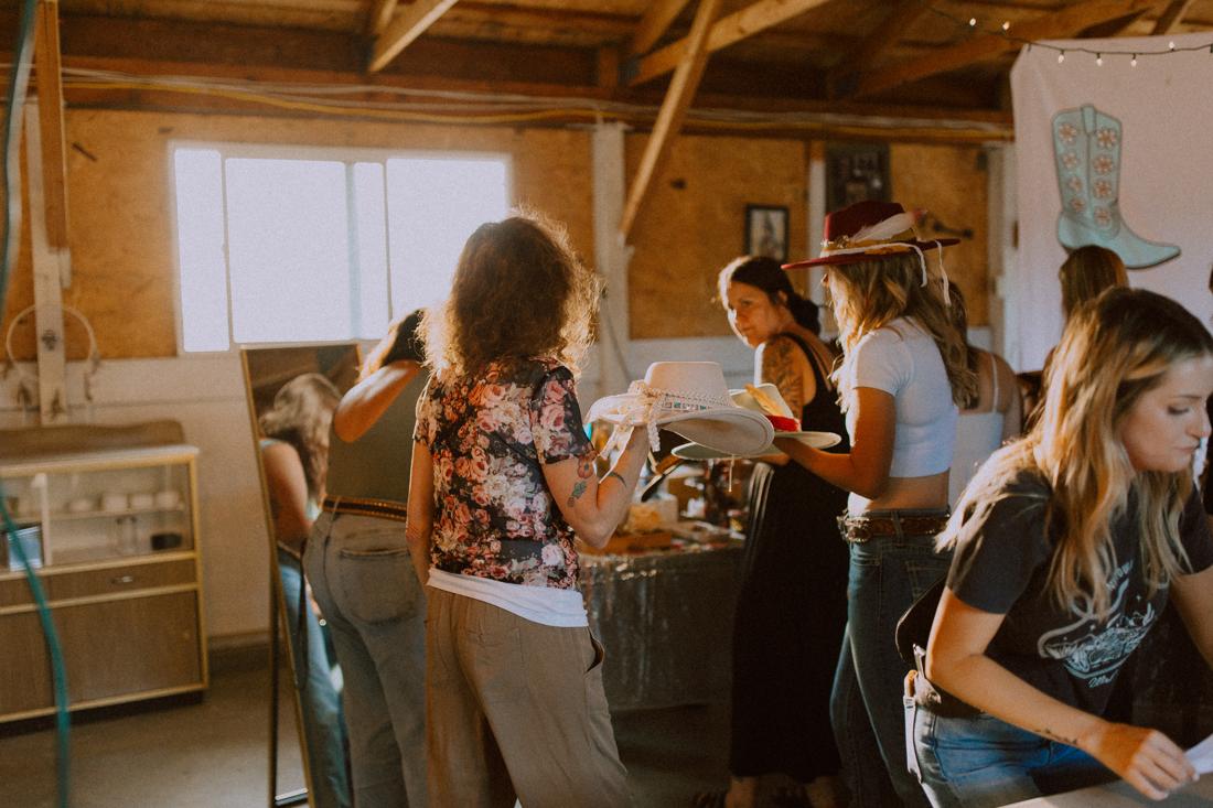 Guests gathered around the hat styling table