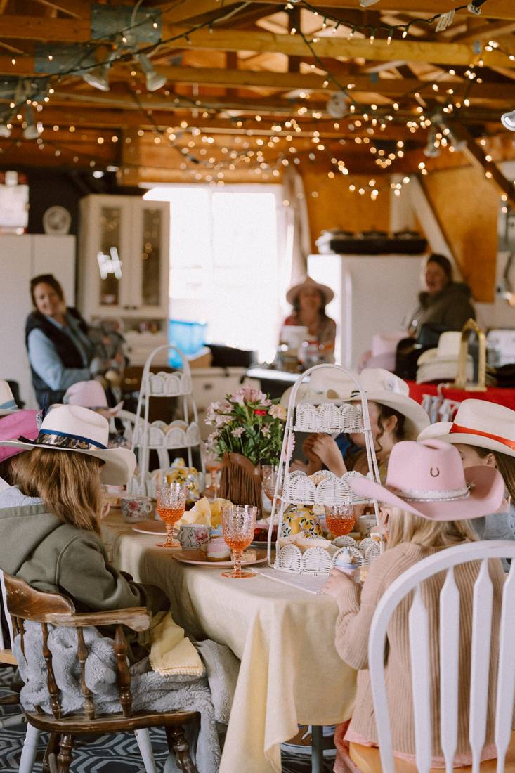 Kids in cowgirl hats at a barn tea party