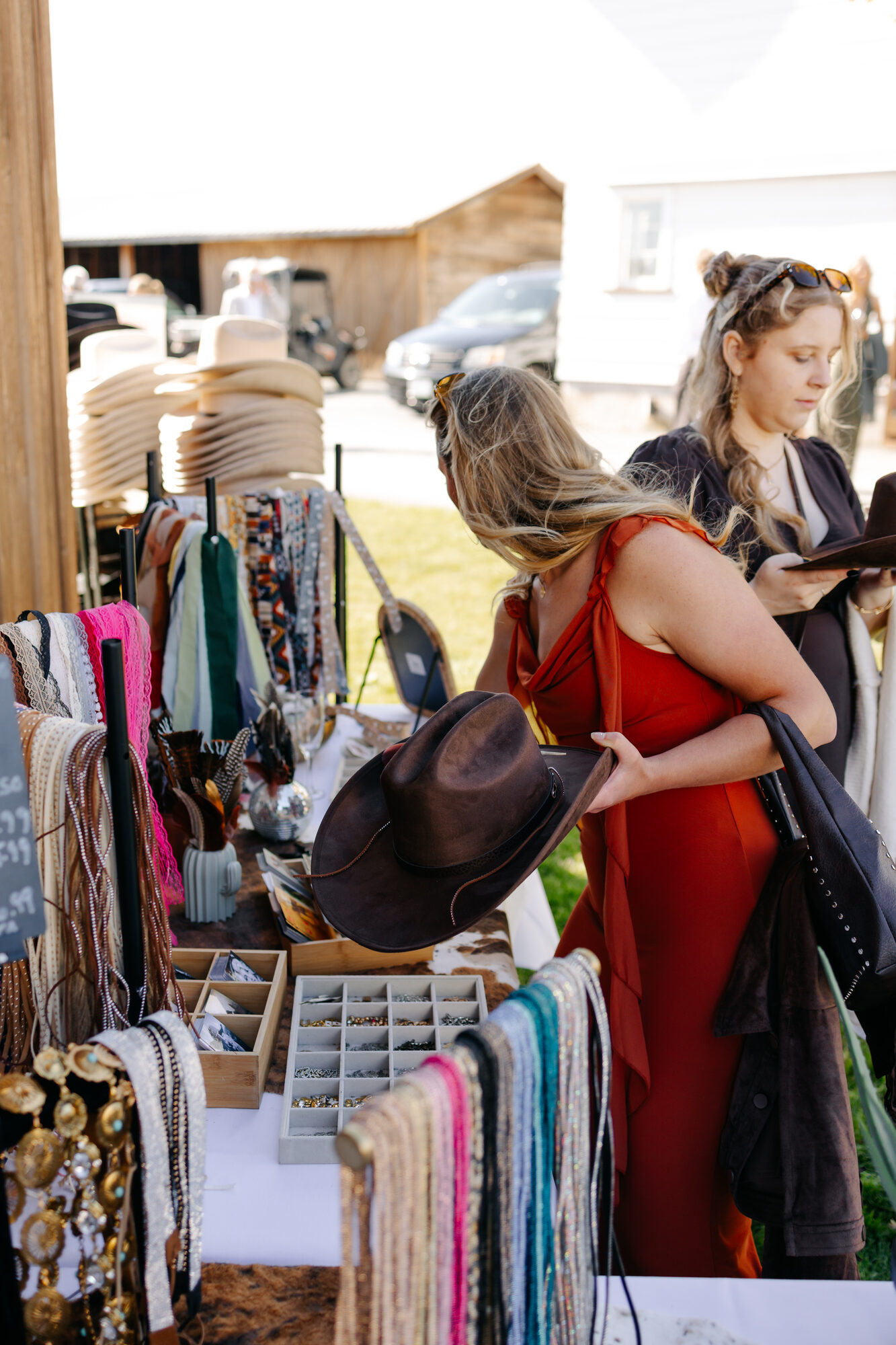 Two guests choosing hats and toasting