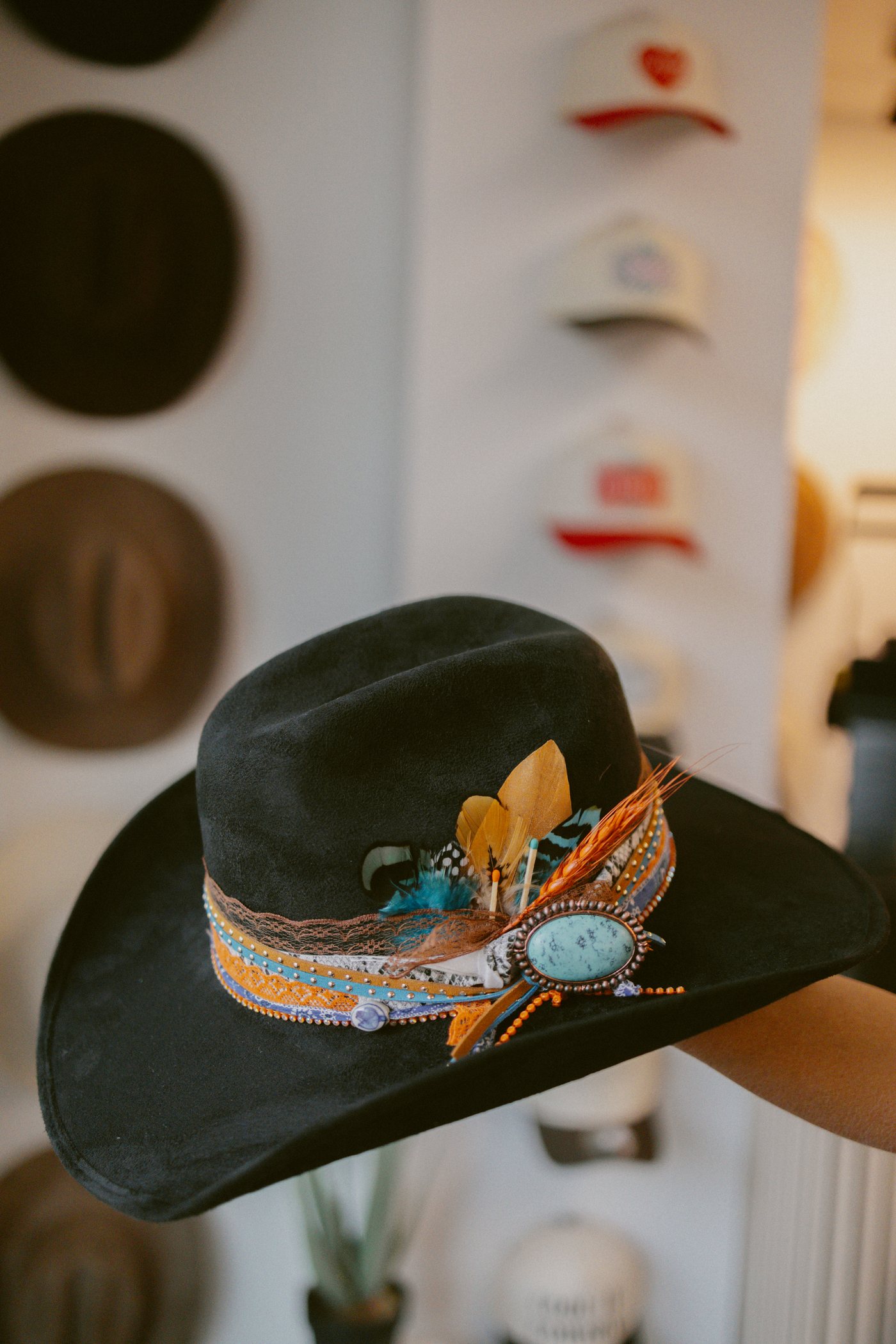 Custom hat with feather and turquoise concho detail at Saddle N Spurs Kelowna