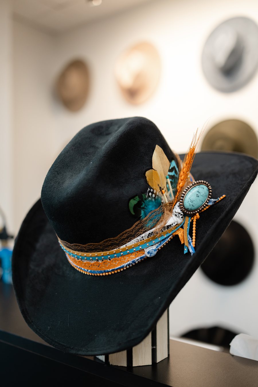 Custom hat with turquoise concho and feather detailing made at Saddle N Spurs Kelowna