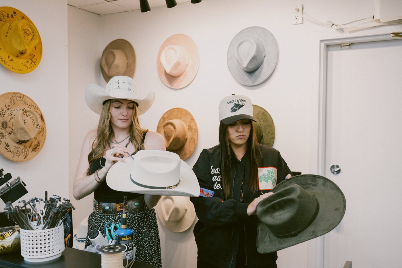 Staff helping a customer craft a custom hat at Saddle N Spurs Kelowna
