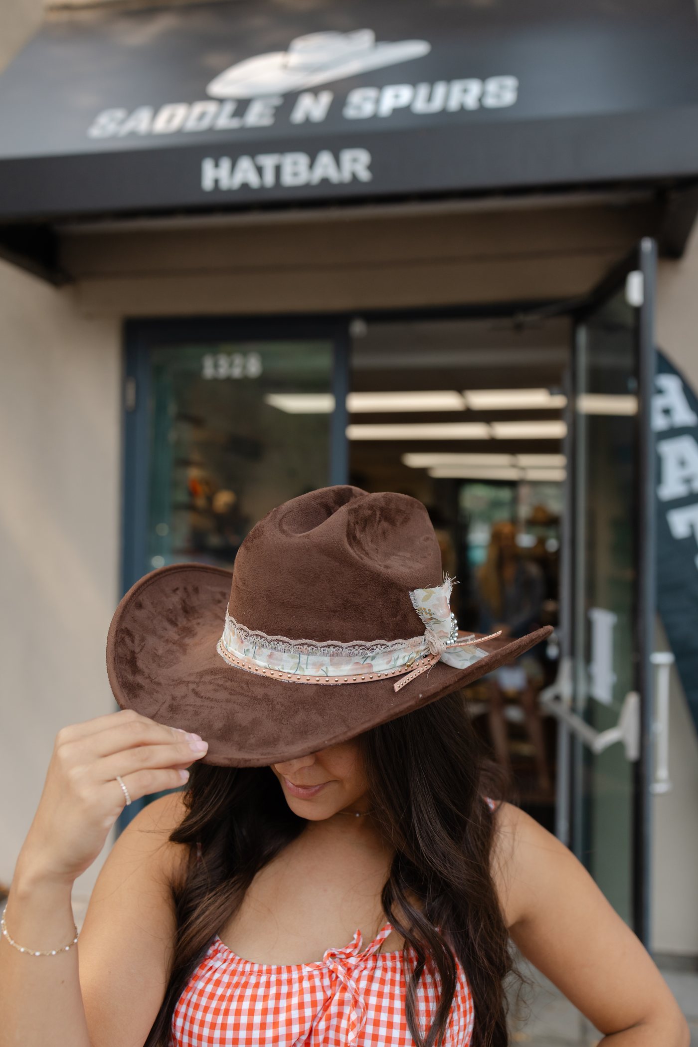 Custom brown hat outside Saddle N Spurs Kelowna, 1328 Water St
