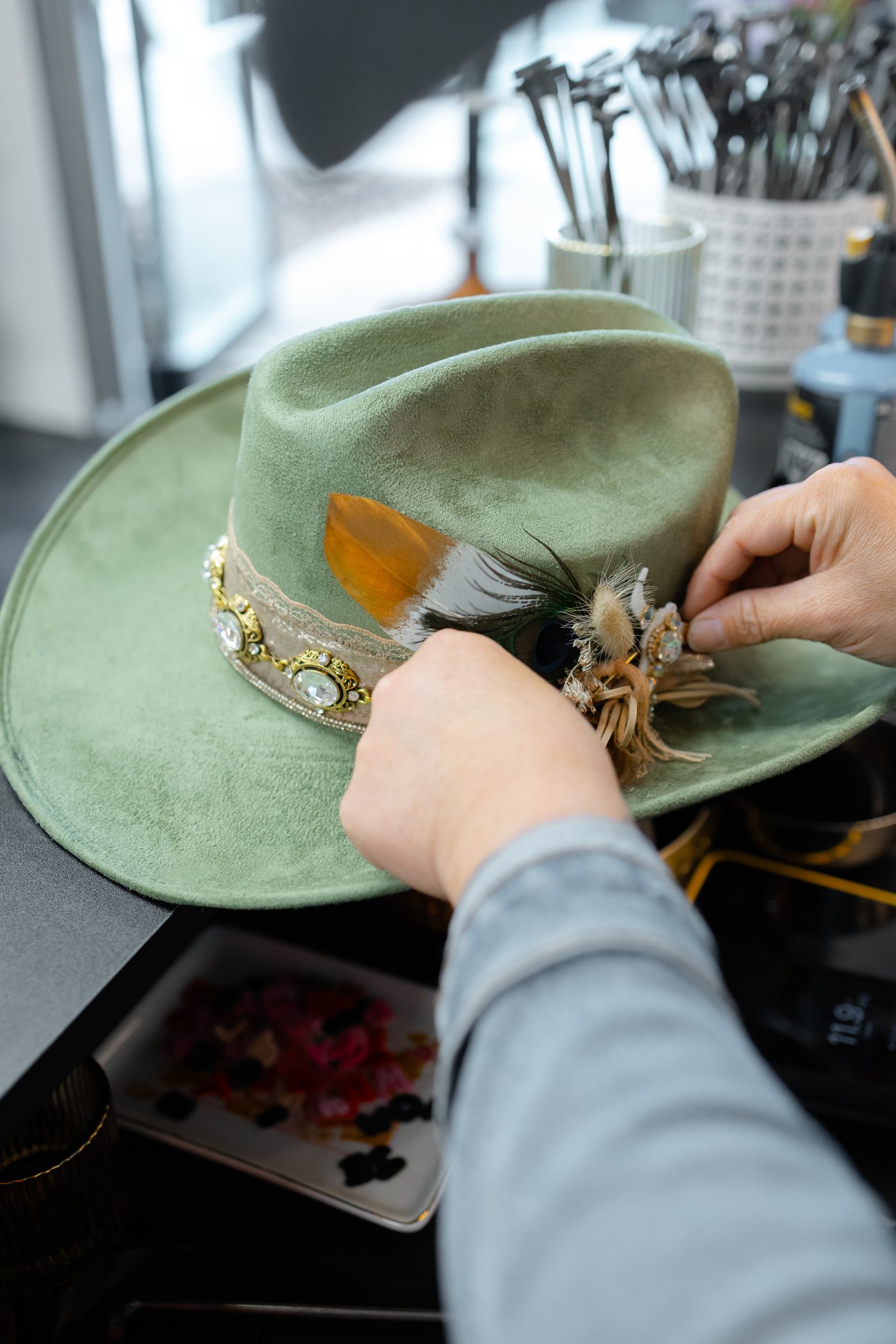 Sage green custom hat with feather detail at Saddle N Spurs Kelowna