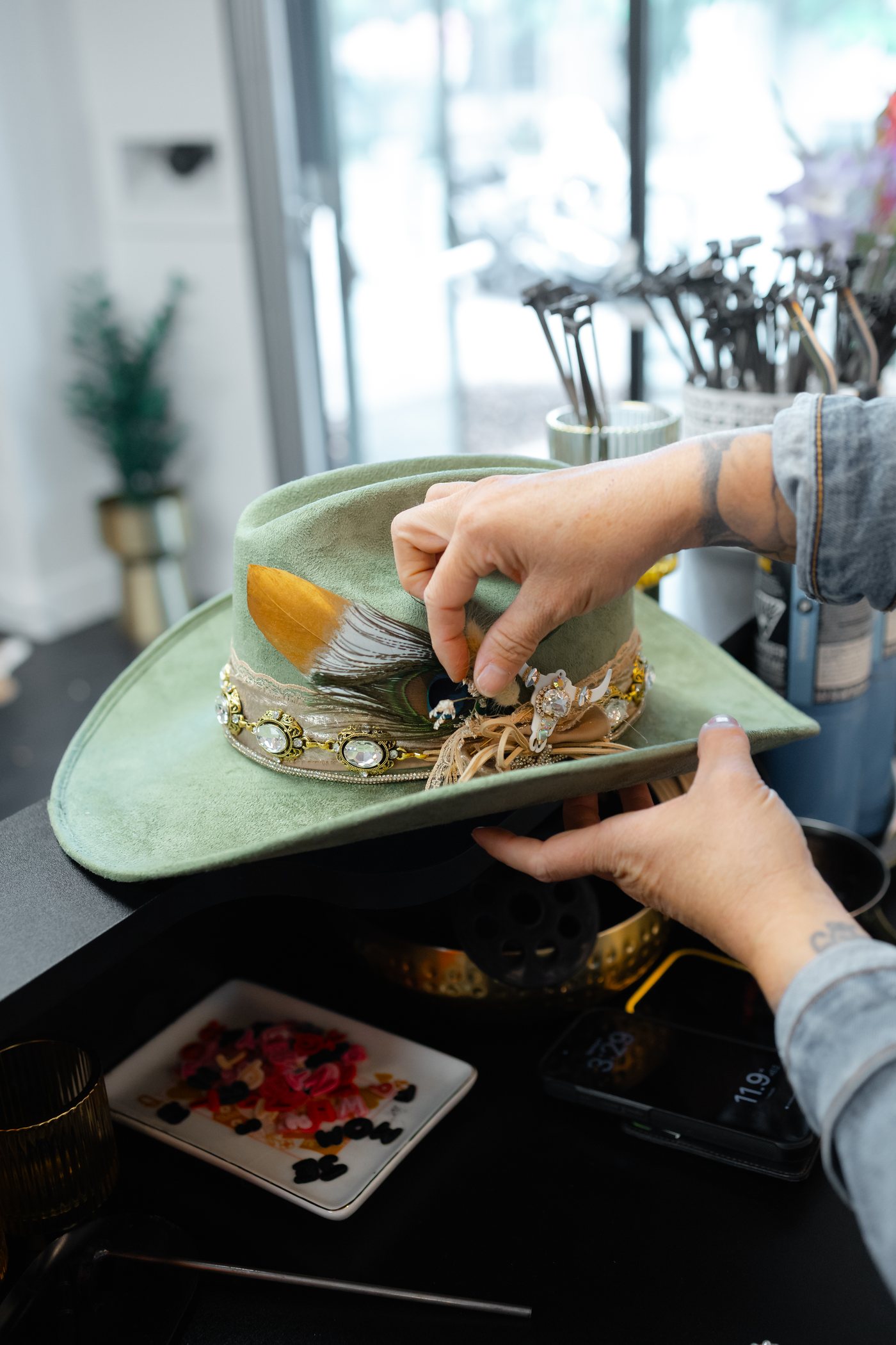 Sage green custom hat with jewelry chain detail at Saddle N Spurs Kelowna