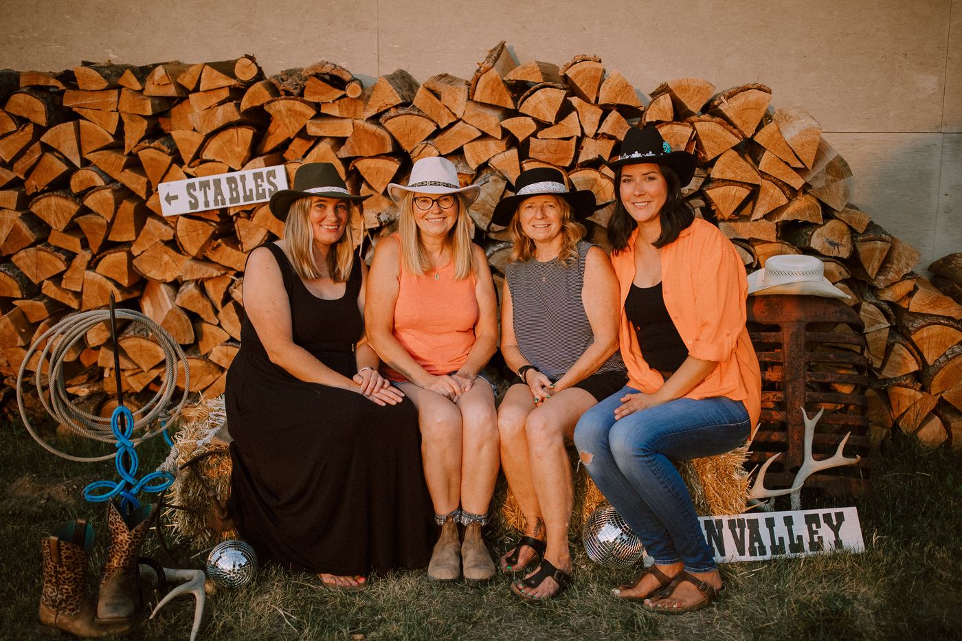 Group of four posing by the Erin Valley stables sign