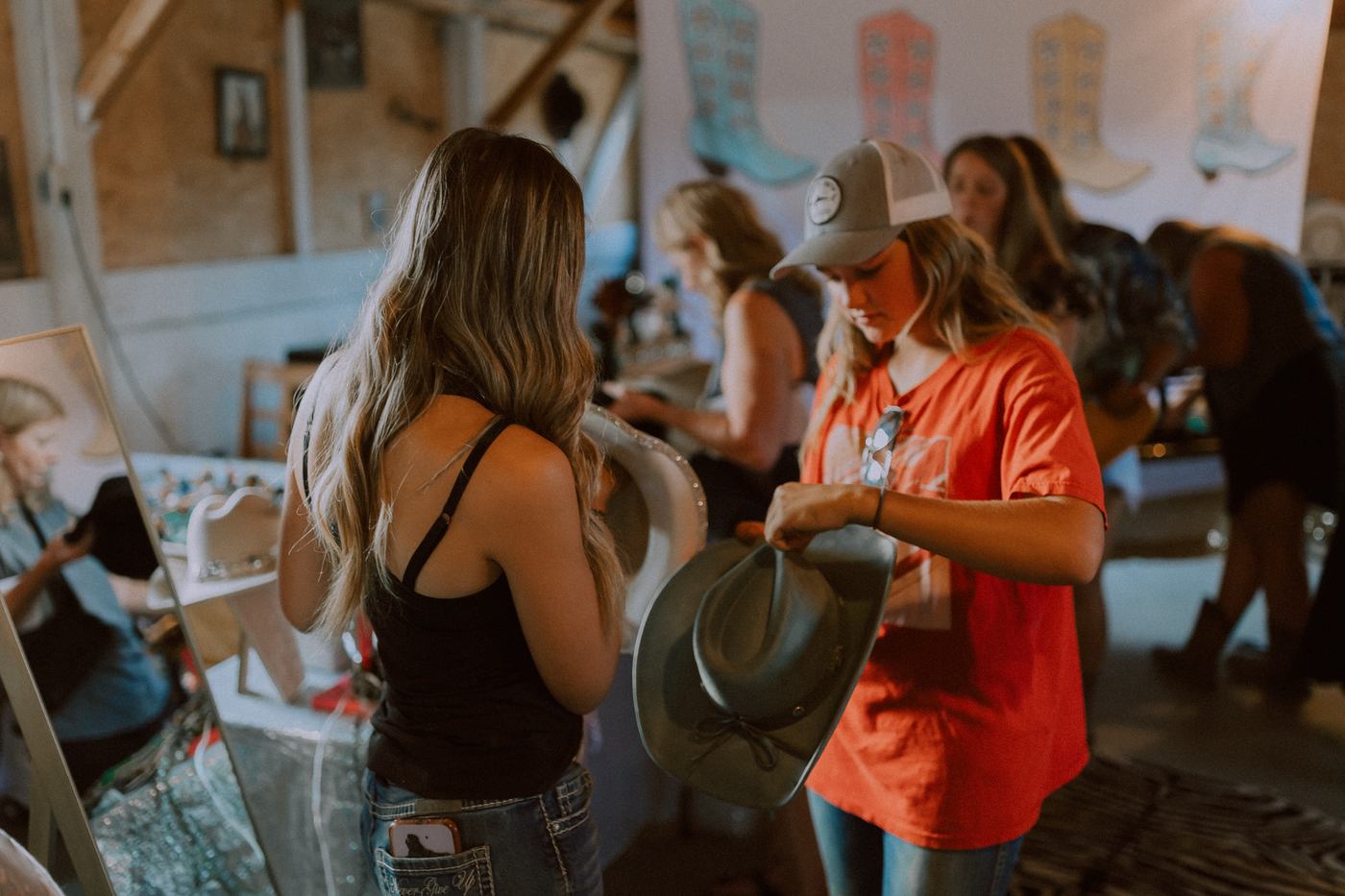 Guest helping style a hat at the Erin Valley hat bar