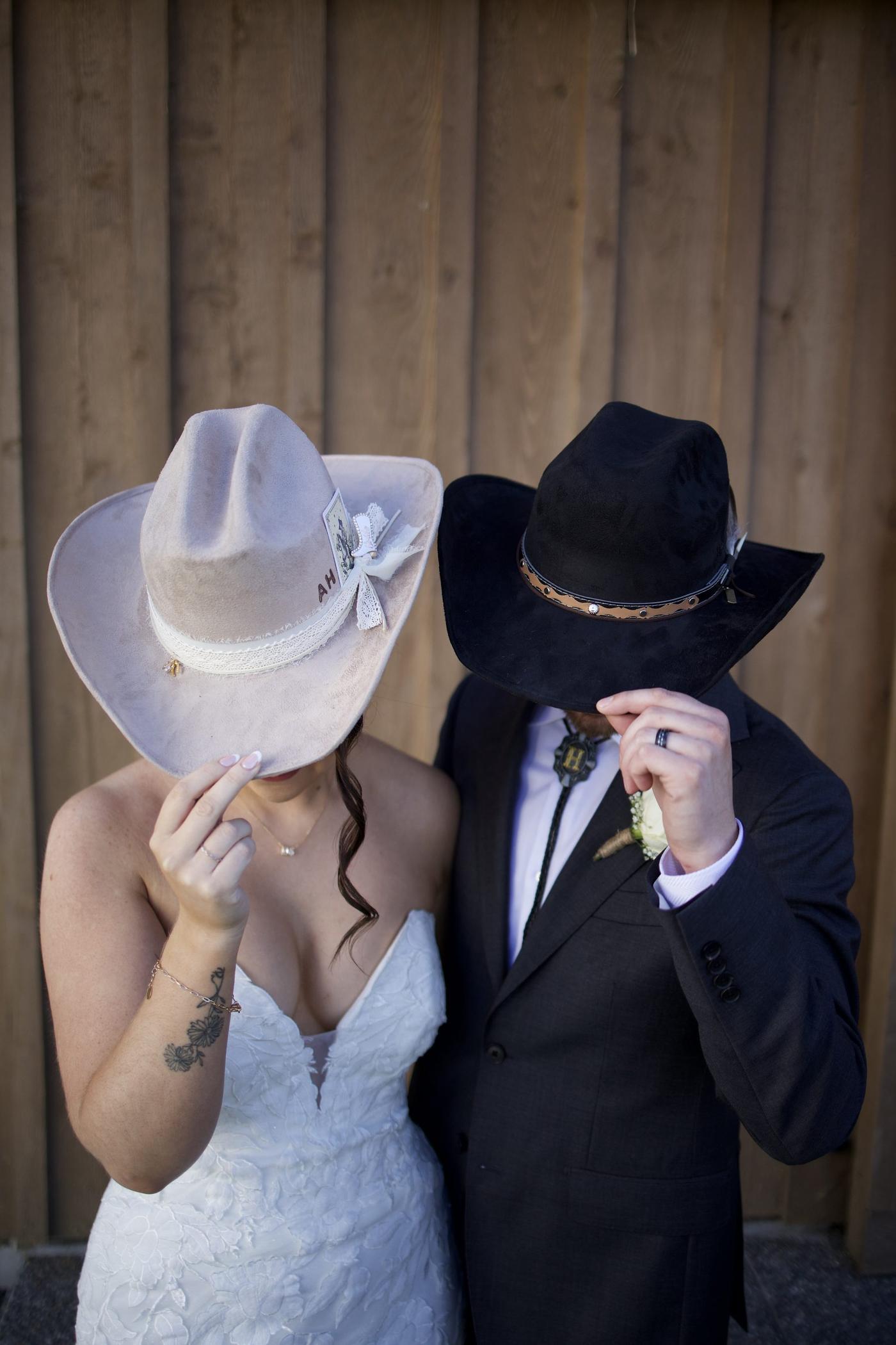 Bride trying on a custom cowboy hat at her Cave Creek Ranch wedding