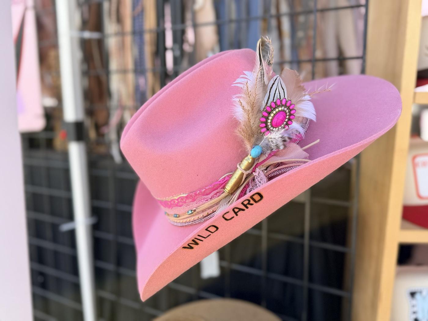 Guests trying on custom hats at the Cloverdale Rodeo booth